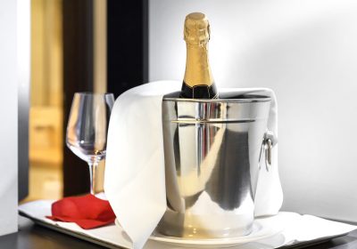 Bottle of cold wine or champagne in ice bucket